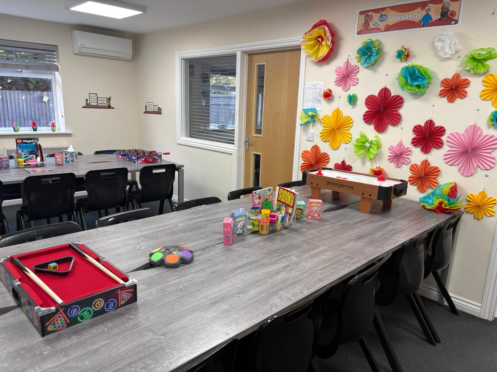 Communal social room with games tables, pool, air hockey and colourful display